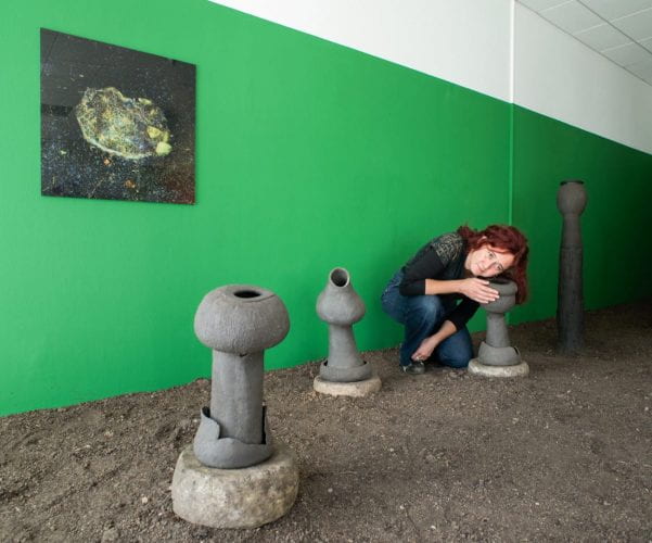 Artist Karine Bonneval with sculptures for her project 