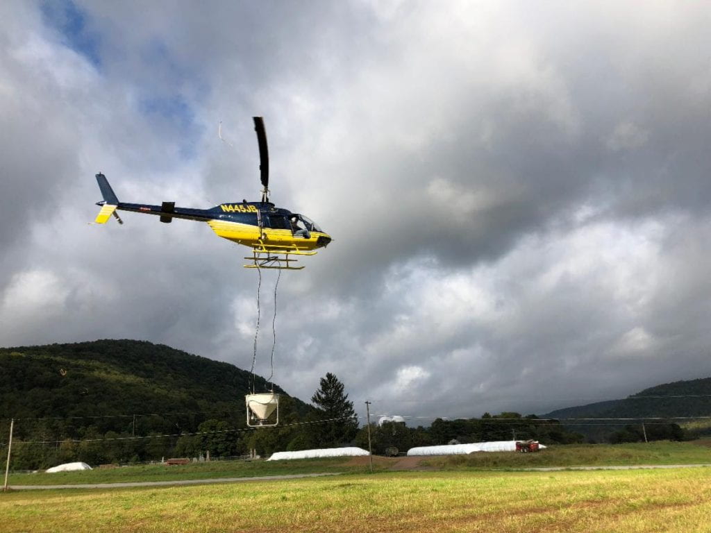 A helicopter will drop winter rye grass seed into standing corn fields to establish a "cover crop" 