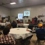 group of farmers at tables attending a soil health workshop