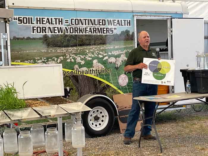 soil health demonstration trailer and instructor with lots of equipment and displays about soil health