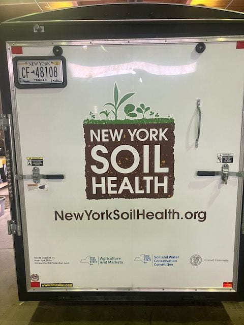 Back doors of New York Soil Health trailer with bold NYSH logo in center